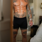 Up close image of a man wearing a black NADS boxer brief