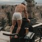 Man outside, going into a cold plunge bucket in a NADS White Organic Cotton Boxer. 
