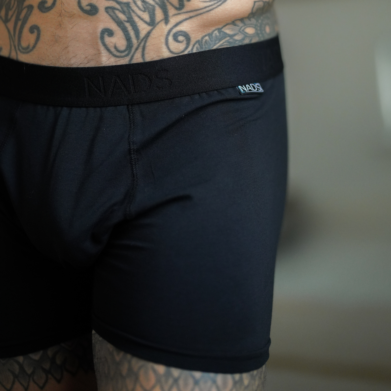Up close image of a man wearing a Black NADS boxer brief