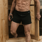 Man standing, facing the camera, coming out of a sauna in a NADS Black Organic Cotton Boxer. 